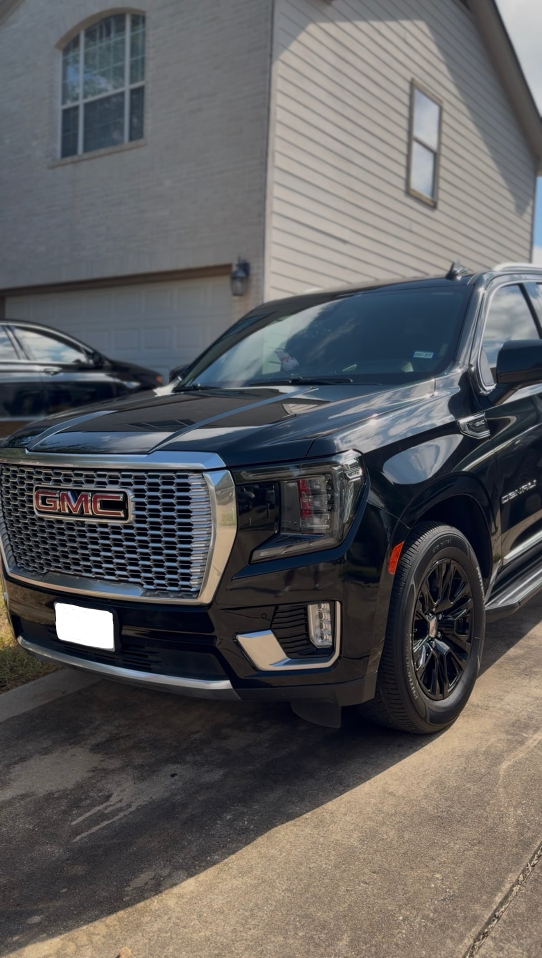 Black GMC Denali SUV with a glossy detailed finish